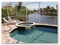 There is also a hot tub  connected to the pool with waterfall spillover into the pool.